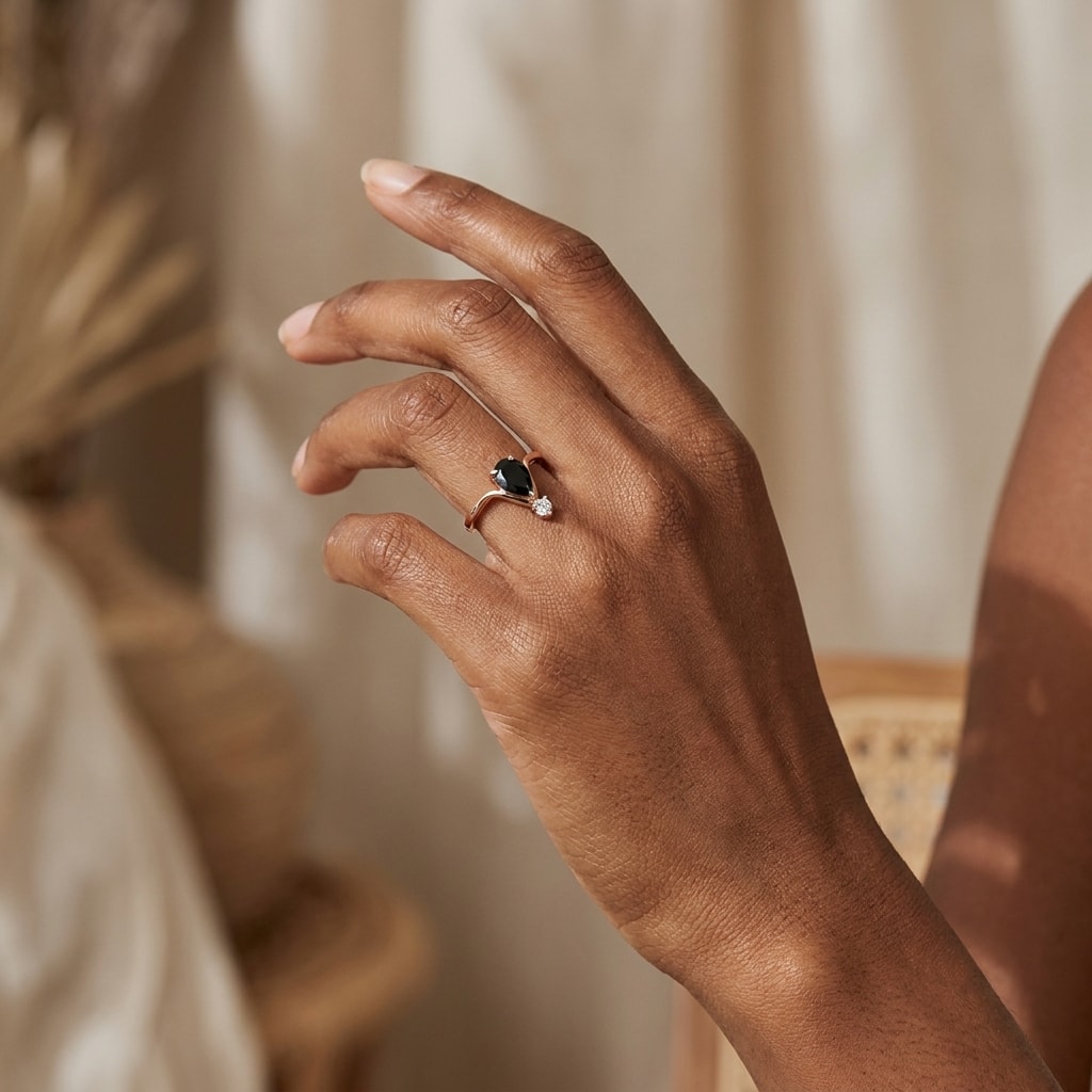 Black_Diamond_Pear_and_Small_Diamond_Engagement_Ring_On_Hand