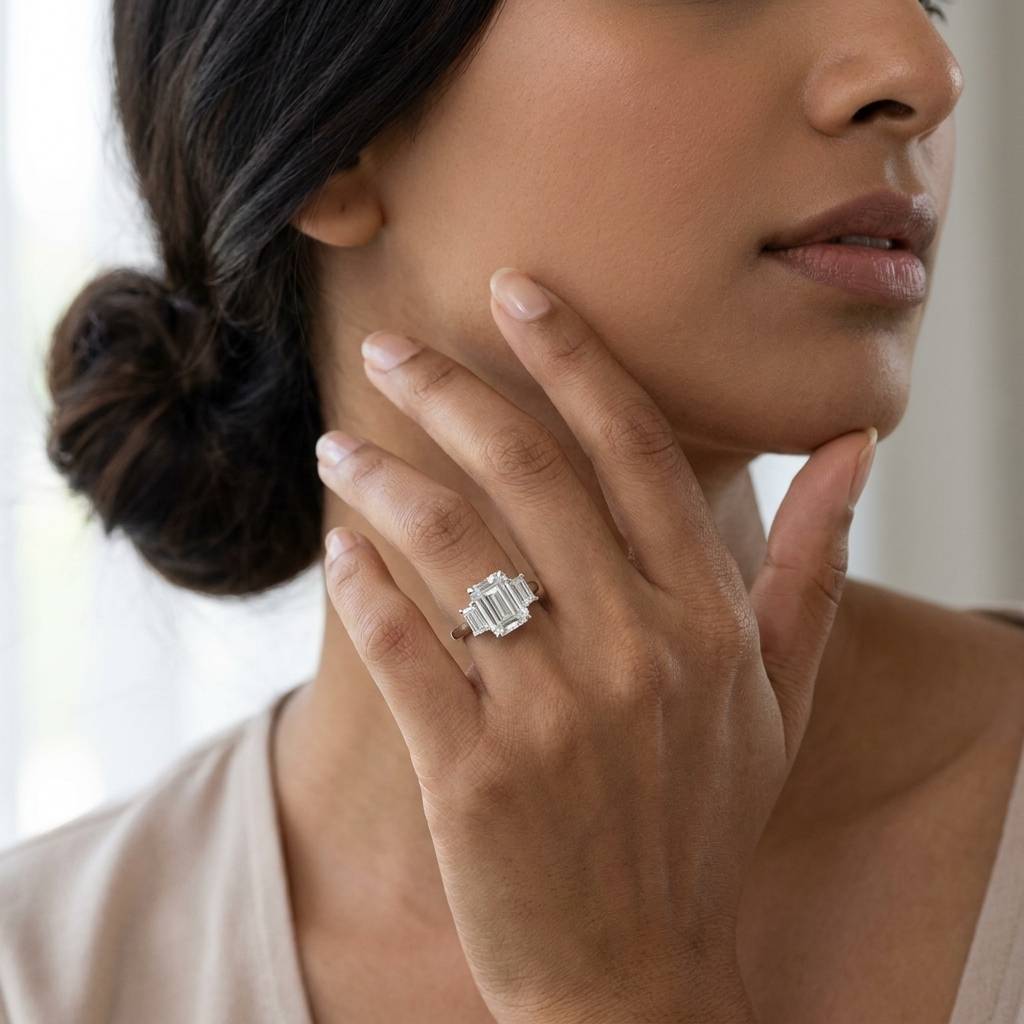Emerald_Shape_Baguette_Side_Trilogy_Platinum_Diamond_Engagement_Ring_On_Model