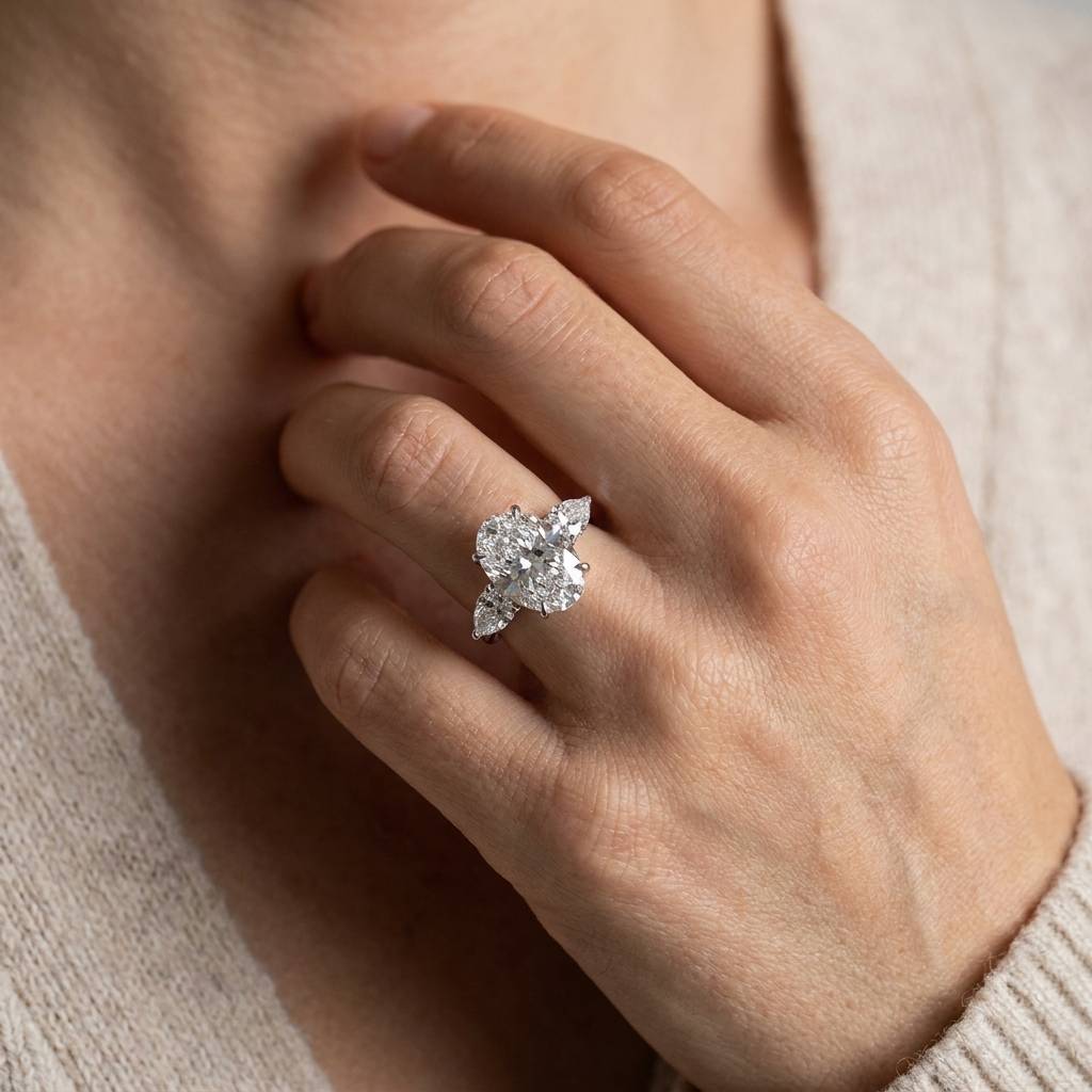 Large_Oval_Shape_Pear_Side_Stones_Diamond_Engagement_Ring_On_Hand