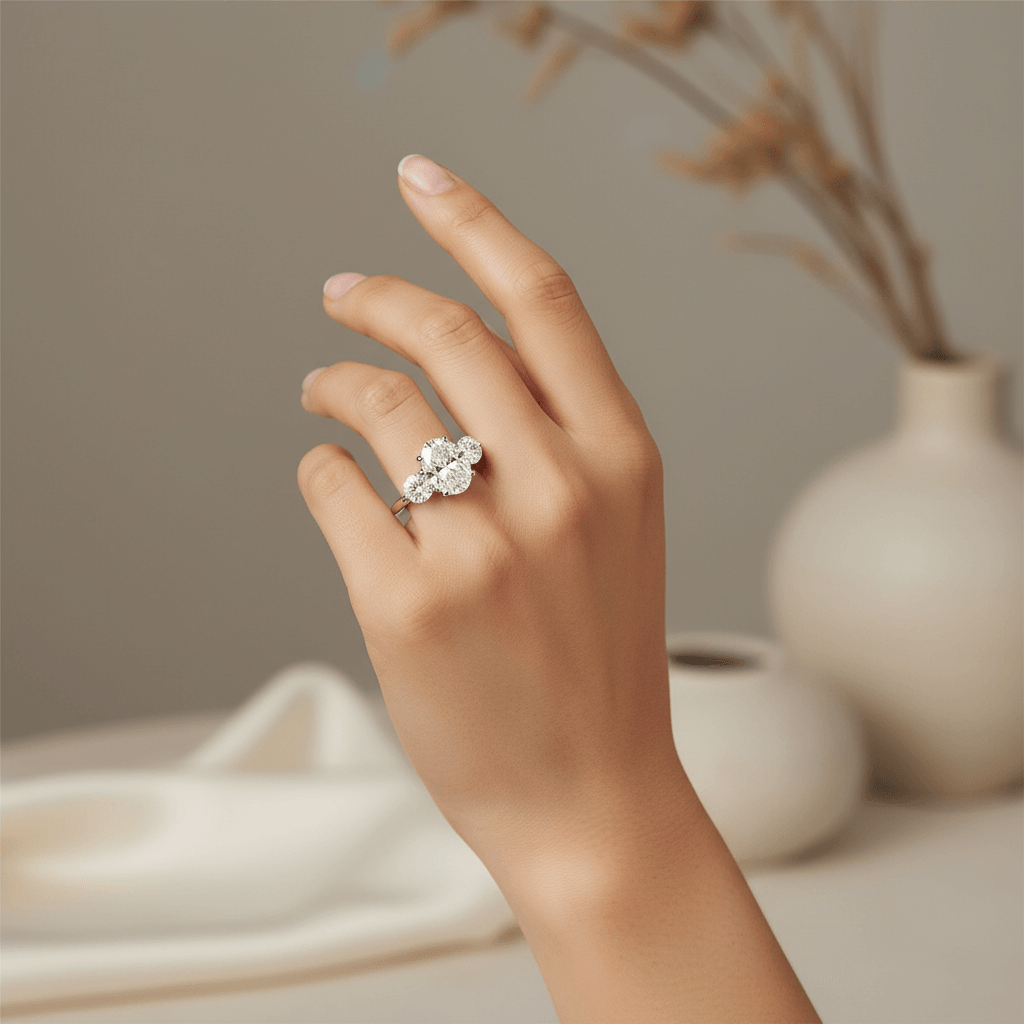 Oval_Side_Rounds_Crossed_Trilogy_Diamond_Engagement_Ring_On_Hand