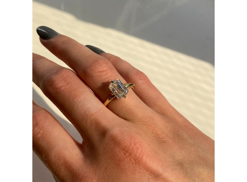 compass setting emerald cut diamond engagement ring on finger2