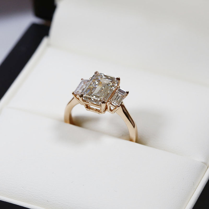 Emerald cut diamond ring with baguette side stones top