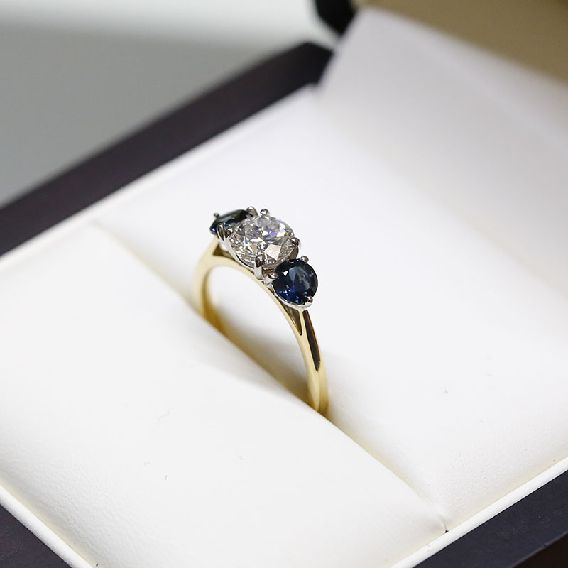 Round Diamond And Teal Sapphires Trilogy Engagement Ring