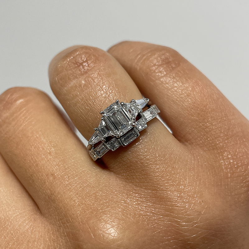 Emerald cut discount ring with trapezoids