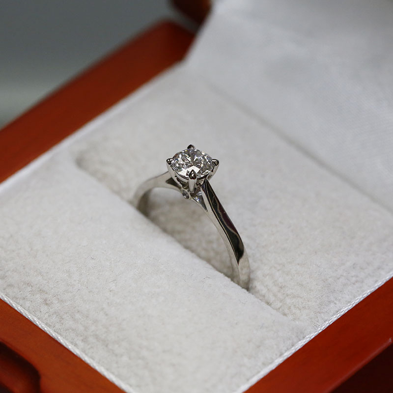 Solitaire Ring with Small Round Diamond Below the Center Stone