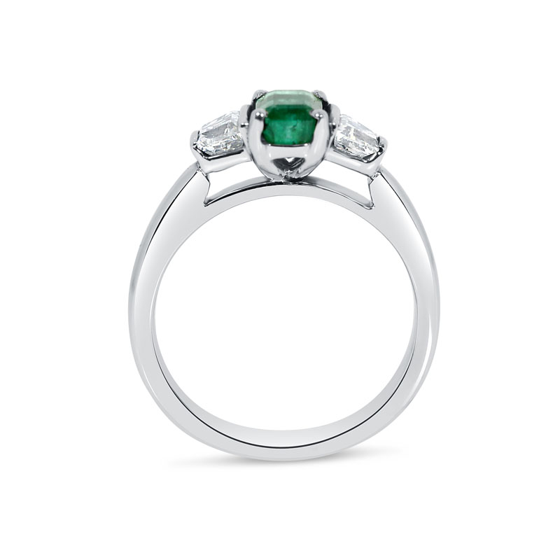 Diamond solitaire with store emerald side stones
