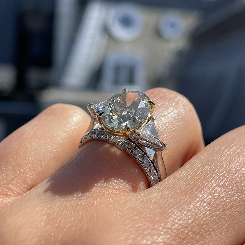 Cushion cut diamond with shop triangle side stones